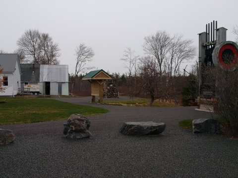Moose River Gold Mines park path with signage and building in the background